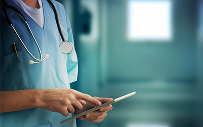 Medical professional in scrubs and wearing a stethescope