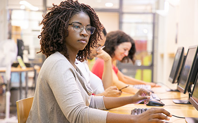 Female student working at a computer terminal